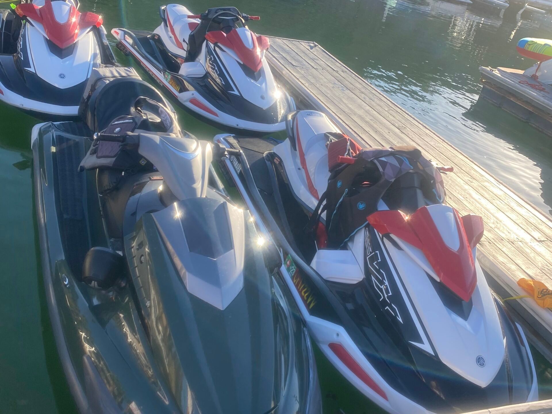 Multiple Jet Ski docked in a body of water